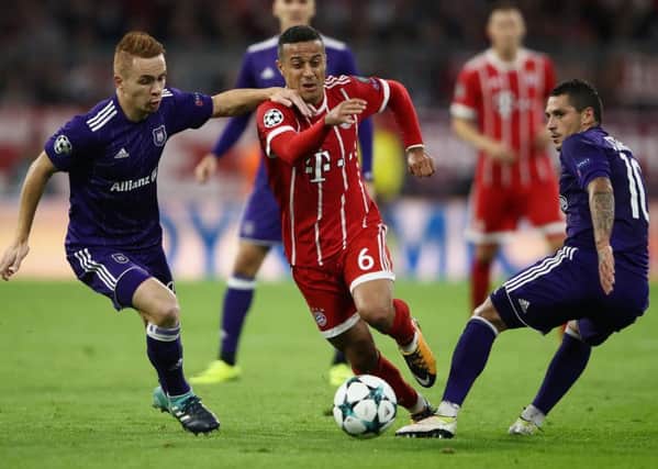 Adrien Trebel, left, and Nicolae Stanciu tussle with Thiago in the Champions League match between Bayern Munich and Anderlecht. Picture: Getty Images