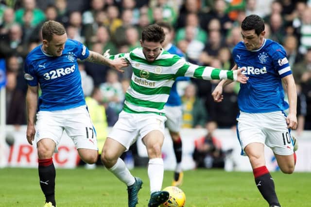 Graham Dorrans, right, wore the captain's armband from the start of the match against Celtic last Saturday. Picture: SNS