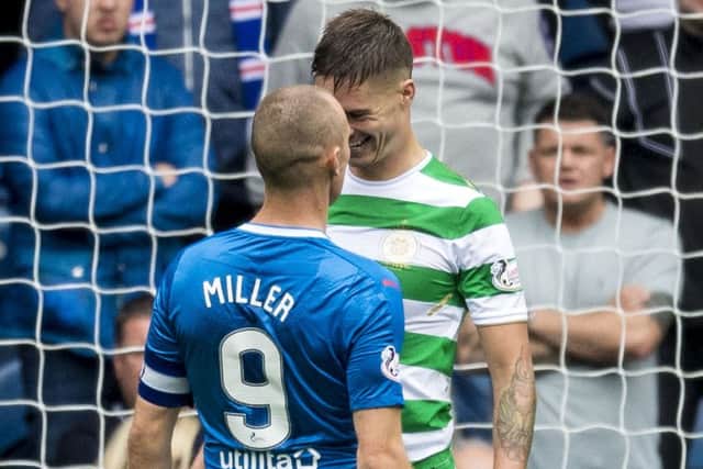 Kenny Miller, with the captain's armband, as he goes face to face with Mikael Lustig. Picture: SNS