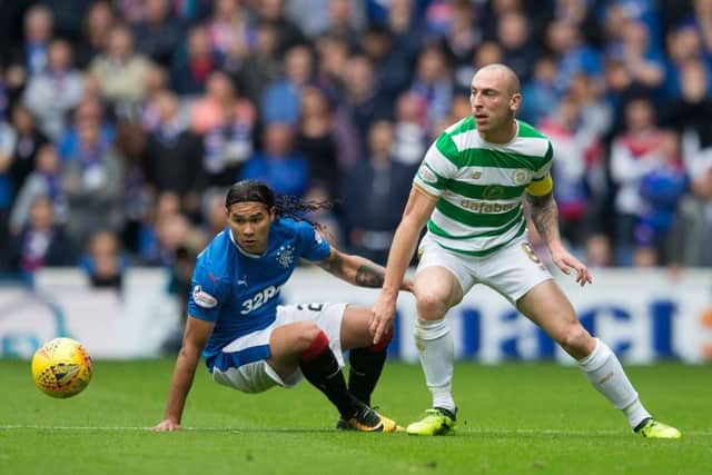 Carlos Pena battles Celtic midfielder Scott Brown for possession during Saturday's OId Firm game. Picture: PA