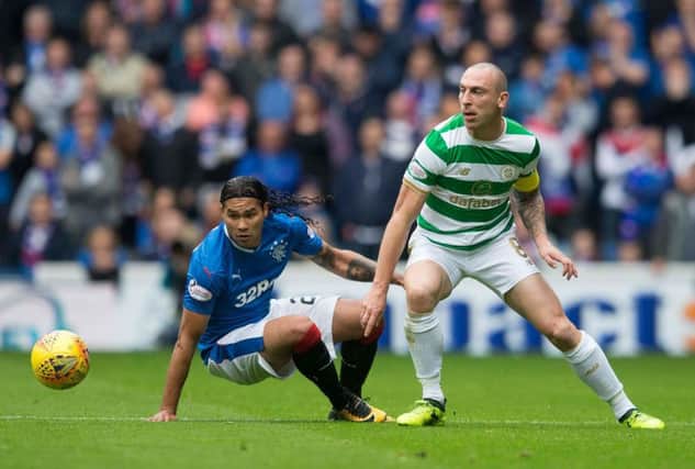 Carlos Pena battles Celtic midfielder Scott Brown for possession during Saturday's OId Firm game. Picture: PA
