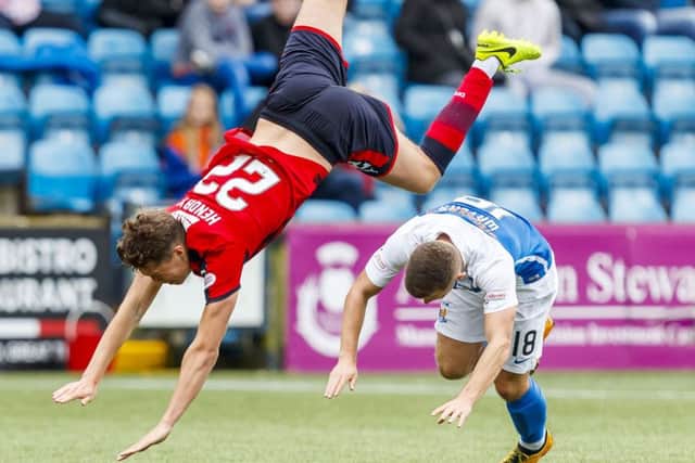 Dundee's Jack Hendry goes flying after a challenge from Calum Waters. Picture: SNS