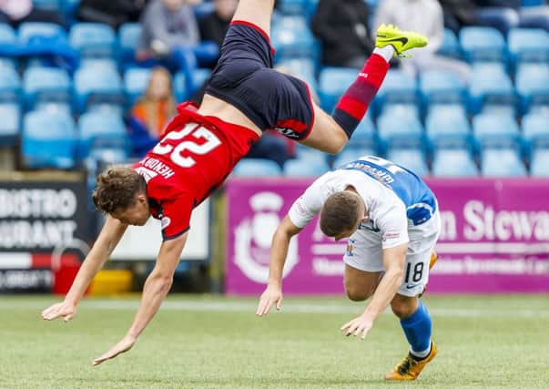 Dundee's Jack Hendry goes flying after a challenge from Calum Waters. Picture: SNS