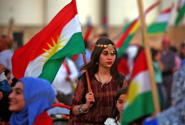 Syrian Kurds wave the Kurdish flag in support of the independence referendum in Iraq's autonomous northern Kurdish region.  Picture: Delil Souleiman/AFP/Getty