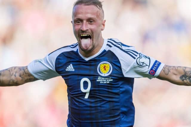From his earliest outings in dark blue, to his double against England, Leigh Griffiths is a changed man, according to Gordon Strachan. Photographs: SNS Group