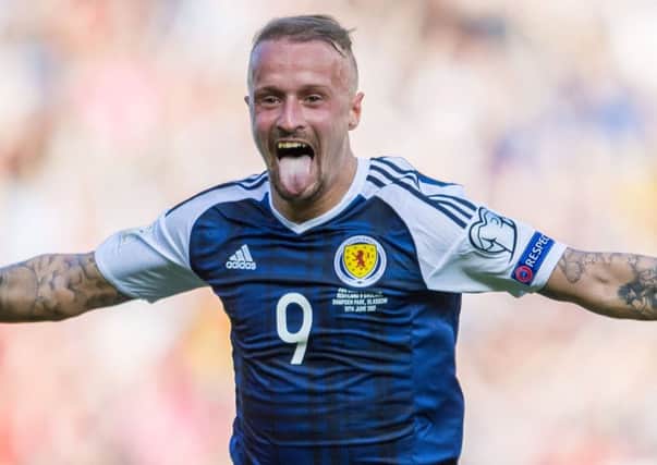 From his earliest outings in dark blue, to his double against England, Leigh Griffiths is a changed man, according to Gordon Strachan. Photographs: SNS Group
