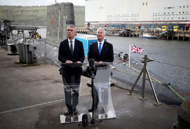 Defence secretary Sir Michael Fallon (right) and Nato Secretary General Jens Stollenberg speak to the media alongside HMS Vengeance during a visit to HM Naval Base Clyde, Faslane. Picture: PA