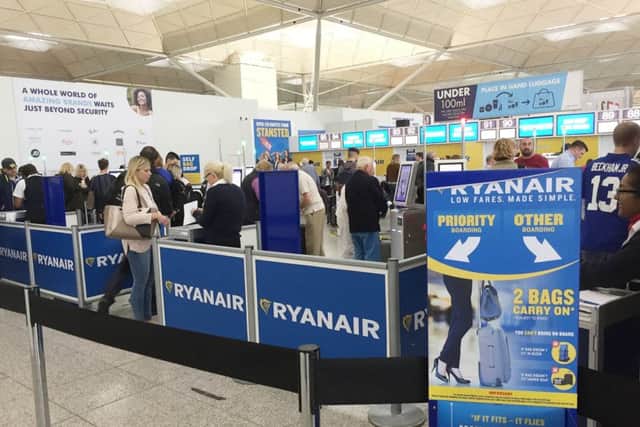 The scene at the Ryanair check-in desks at London Stansted Airport. PA
