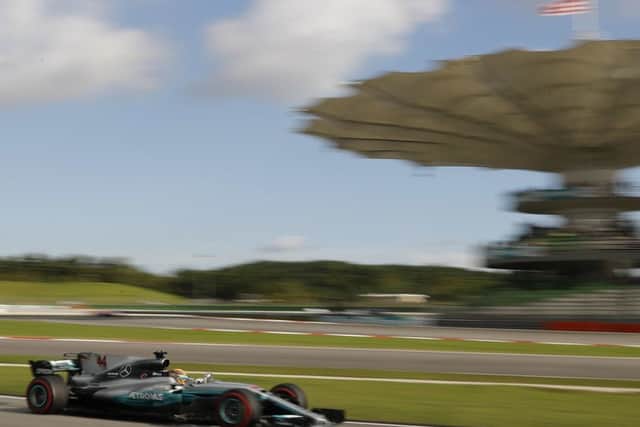 Mercedes driver Lewis Hamilton produces a pole-winning lap at Sepang. Picture: AP
