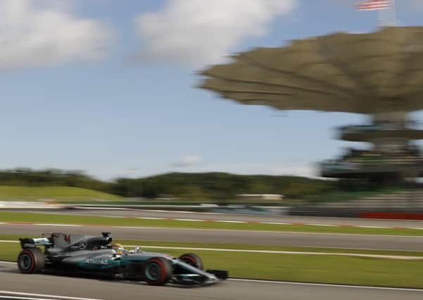 Mercedes driver Lewis Hamilton produces a pole-winning lap at Sepang. Picture: AP