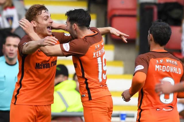 Fraser Fyvie celebrates with former Hibs team-mate James Keatings after making it 1-0. Picture: SNS Group