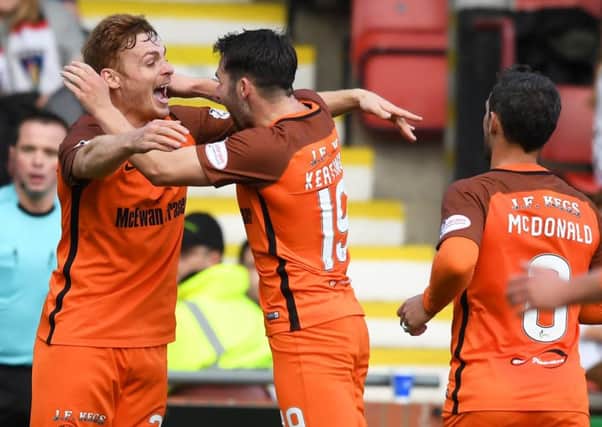 Fraser Fyvie celebrates with former Hibs team-mate James Keatings after making it 1-0. Picture: SNS Group