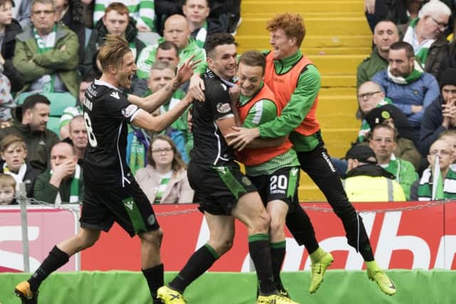 John McGinn celebrates with his team-mates after scoring his, and Hibs' second at Parkhead. Picture: SNS Group