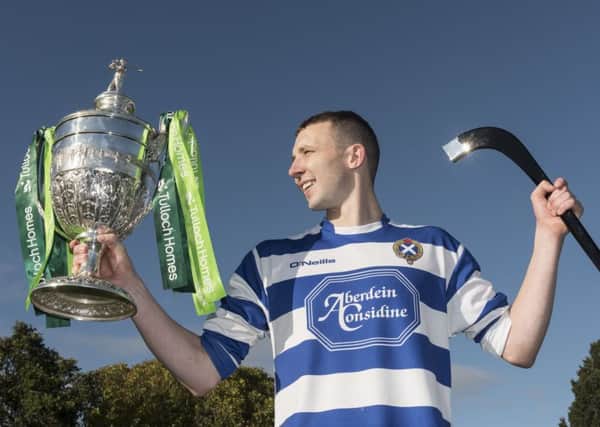 Newtonmore captain Rory Kennedy, who was an inspiration to his team, lifts the Camanachd Cup. Photograph: Neil G Paterson
