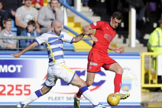 Gary Harkins of Morton and Aaron Muirhead of Falkirk vie for the ball. Picture: Michael Gillen