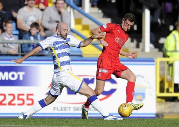 Gary Harkins of Morton and Aaron Muirhead of Falkirk vie for the ball. Picture: Michael Gillen