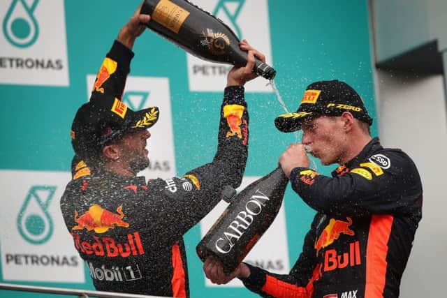 Max Verstappen, right, celebrates with Red Bull team-mate Daniel Ricciardo after his victory in Penang. Picture: Getty.