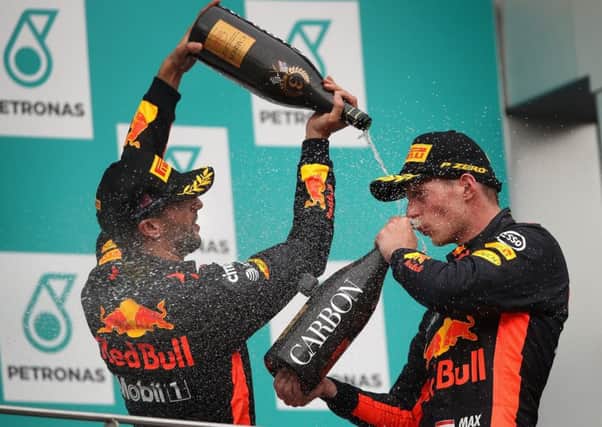 Max Verstappen, right, celebrates with Red Bull team-mate Daniel Ricciardo after his victory in Penang. Picture: Getty.