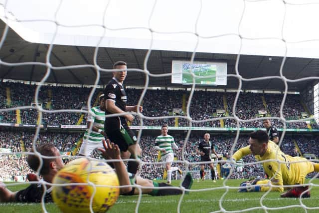 Callum McGregor fires the ball past Ross Laidlaw to rescue a point for Celtic. Picture: SNS.