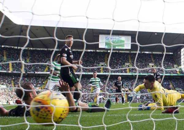 Callum McGregor fires the ball past Ross Laidlaw to rescue a point for Celtic. Picture: SNS.