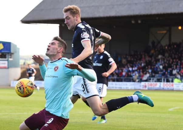 Hearts striker Kyle Lafferty is challenged by Dundee's Kevin Holt. Pic: SNS