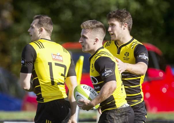 Ross McCann celebrates the first of his four tries on Saturday with Nyle Godsmark and Jason Baggott. Picture: SNS.
