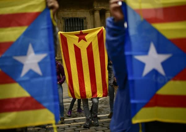 Pro-independence supporters hold up ''esteleda'' or Catalan pro independence flags, in support of the Catalonia's referendum. Picture: AP