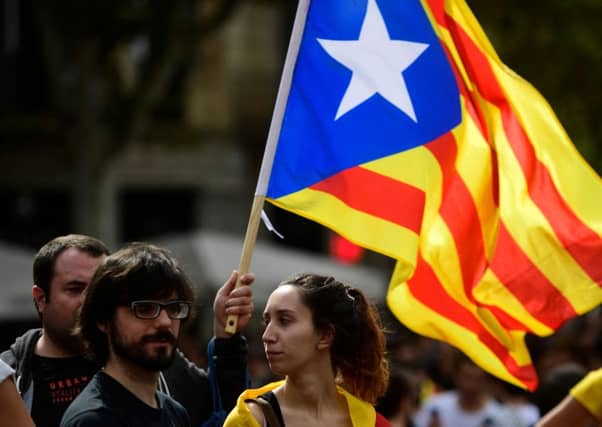 Students wave a Catalan pro-independence 'Estelada' flag during a protest in Barcelona on Monday. Picture: AFP/Getty Images