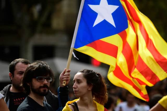 Students wave a Catalan pro-independence 'Estelada' flag during a protest in Barcelona on Monday. Picture: AFP/Getty Images