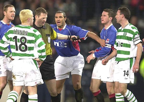 Lorenzo Amoruso (centre) playing peacekeeper and keeping Barry Ferguson and Neil Lennon apart in the 2002 CIS Cup semi-final. Picture: David Moir