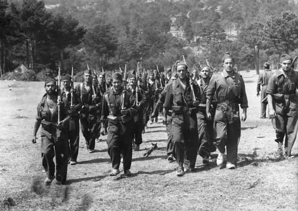Republican soldiers moving up to the front lines in the Guadarrama Mountains during the Spanish Civil War.  (Photo by Ward/Fox Photos/Getty Images)