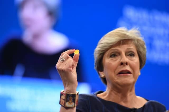 Prime minister Theresa May shows off a sweet handed to her by chancellor Philip Hammond after suffering a coughing fit during her conference speech in Manchester. Picture: PA