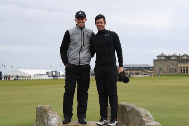 Connor Syme with Rory McIlroy on the Swilcan Bridge in St Andrews. Picture: Ross Kinnaird/Getty Images