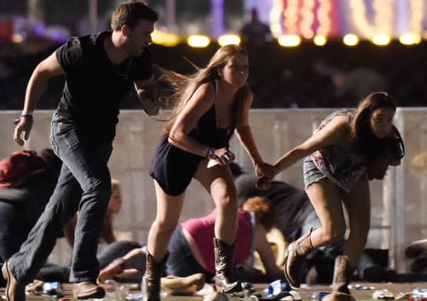 People run to safety from the Route 91 Harvest country music festival. Picture: Getty