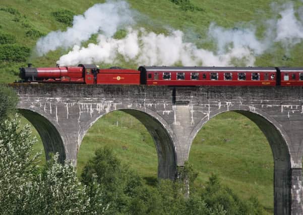 A train crosses the Glenfinnan viaduct as seen in the Harry Potter films. Photograph: NTS