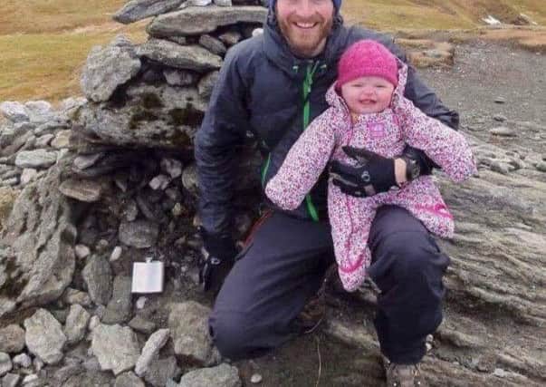 Baby Rebecca Lamb at the top of a Munro with dad Gordon. Picture: SWNS