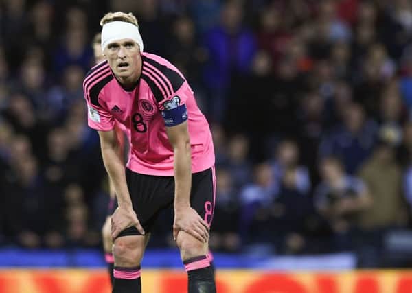Scotland captain Darren Fletcher sports a bandaged head after sustaining a nasty cut to his ear from a Slovakian elbow.  Picture: Craig Williamson/SNS