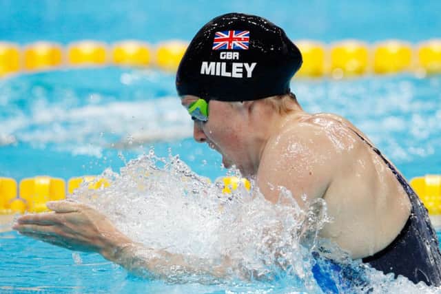 Double gold: Hannah Miley  in action in the pool earlier this year, top  celebrates winning in Delhi, above, and Glasgow, far left.
Photographs: Getty Images