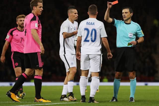 Robert Mak of Slovakia is shown a red card by referee Milorad Mazic. Picture: Getty