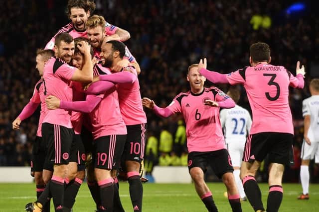 Scotland's players celebrate after the winning goal. Picture: SNS