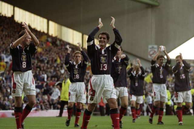 Paul Lambert, left, and Tosh McKinlay, centre, salute the Scotland fans after all but securing a place at the 1998 World Cup finals. Picture: Gareth Reid/SNS