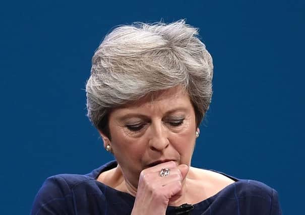 The Prime Minister in mid coughing fit during her speech in Manchester. Picture: Carl Court/Getty