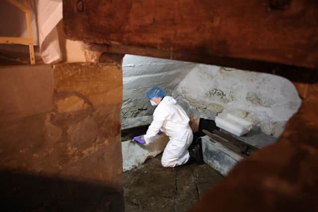 Forensic scientists examine bones from the crypt at Wardlaw Mausoleum.PIC: Peter Jolly