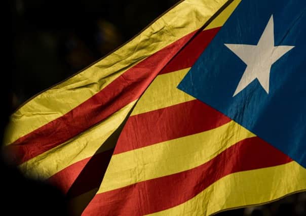 A Catalan flag waves after thousands gathered in Barcelona to protest the violence that marred last Sunday's referendum vote. Picture: Getty