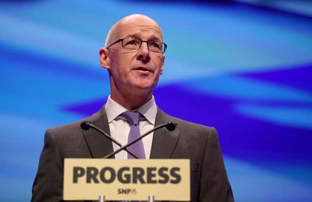 John Swinney delivers the opening address to delegates at the SNP conference at the SEC Centre in Glasgow. Picture: PA