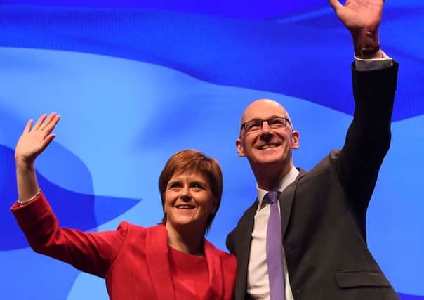 Nicola Sturgeon and John Swinney on the opening day of the SNP annual conference in Glasgow. Picture: AFP/Getty