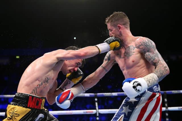 Ricky Burns, right, and Anthony Crolla exchange blows during their lightweight contest at Manchester Arena on Saturday night. Picture: Alex Livesey/Getty Images