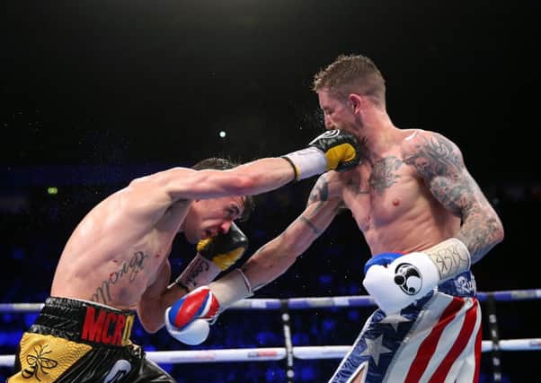 Ricky Burns, right, and Anthony Crolla exchange blows during their lightweight contest at Manchester Arena on Saturday night. Picture: Alex Livesey/Getty Images