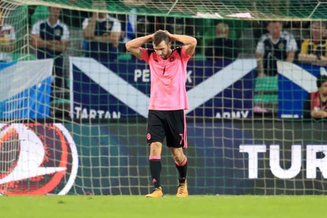 Dejection for Scotland and James McArthur as they fail to secure the three points necessary. Picture: PA