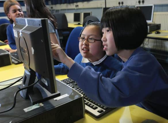 Dalry primary school pupils Kelly Zheng (right), 10, and Jennifer Shek, nine, work together on a digital animation project in Edinburgh. Picture: Tom Finnie